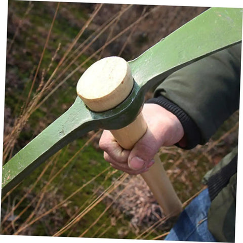 Close-up of steel garden hoe handle multifunctional pickaxe being held, showcasing sturdy wood handle for gardening use.