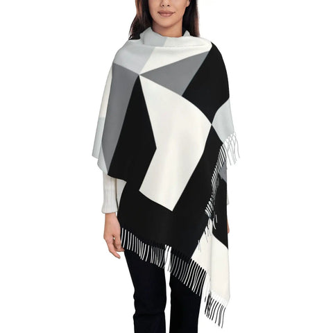 Black And White Piano Grid Winter Scarf Crafted From Plush Faux Cashmere With Extended Fringe Edges draped on model, perfect for chilly days.