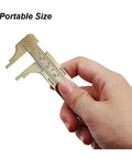 Solid Brass Digital Caliper High-Precision Mini Tool Crafts Jewelry held in hand, portable size for easy measurement.