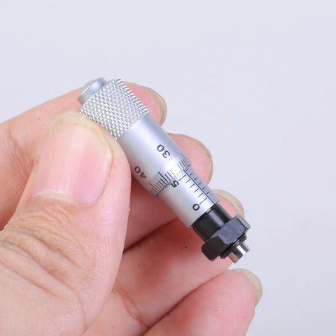 Hand holding 0 To 6.5 Inches Carbon Steel Micrometer Head Workhorse Gauge For Engineers with flat needle and plain thimble