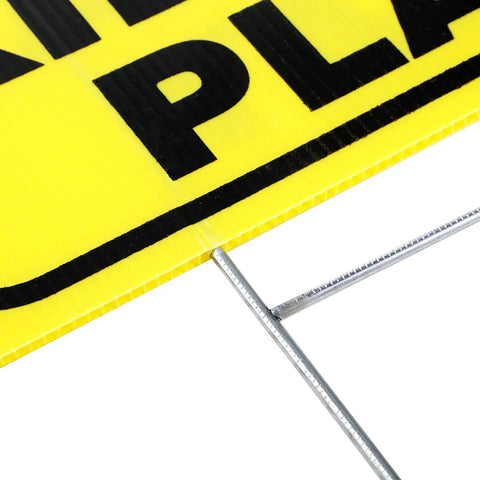 Close-up of yellow Slow Down Kids At Play Signs With Metal Stakes Four Pack 12 By 16 Inch Double Sided Caution Signs corner view