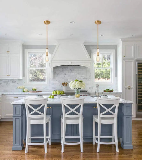 Sleek Modern Brass Glass Kitchen Pendant Light With Rod-Hung Design illuminating a contemporary kitchen with white cabinets.