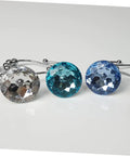 Close-up of colorful crystal-accented 12 Pack Glide Shower Ring Hooks for Curtain and Liner on a smooth white surface