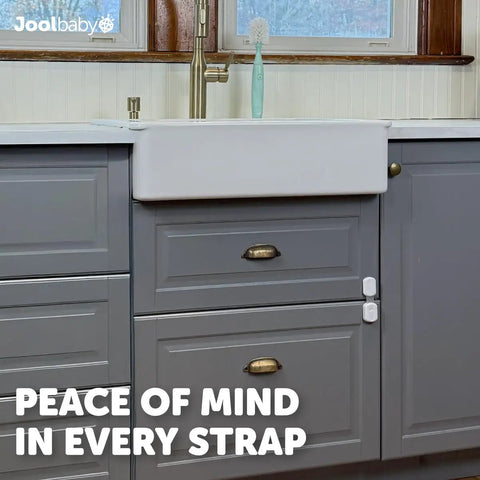 Gray kitchen cabinets secured with Four Pack Baby Proof Cabinet, Drawer, Fridge, Toilet And Trash Can Locks With 3M Adhesive.