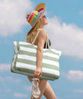 Woman carrying Ultra Roomy Waterproof Beach Tote For Women With Secure Zipper Closure Large Sandproof Swim Pool Bag on a sunny day