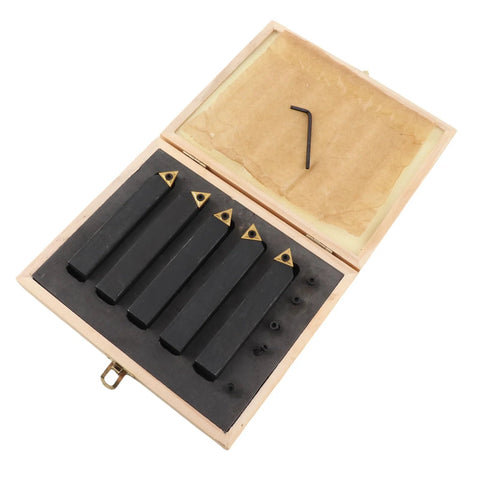 Open wooden box with five black carbide turning tools featuring gold inserts and a hex key