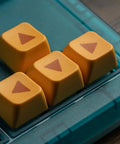 Close-up of four yellow keycaps with arrows on a Retro 87 Key Wireless Mechanical Keyboard Hot Swap Silky Linear Switches.