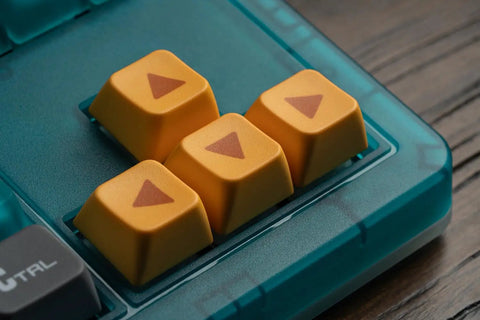 Close-up of four yellow keycaps with arrows on a Retro 87 Key Wireless Mechanical Keyboard Hot Swap Silky Linear Switches.