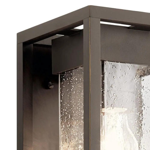 Close-up of Mercer 12 Inch Outdoor Wall Light One Light With Clear Seeded Glass In Olde Bronze Finish For Entryways Patios Porches And Garages Downward Lighting Weather Resistant Exterior Sconce With Classic Curb Appeal showcasing seeded glass texture and bronze finish.