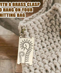 Wooden Yarn Wrap Guide Board With Clasp WPI Gauge hanging on crochet bag, spiral leaves design for spinners and crafting.