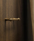 Antique Brass Zinc Alloy Cabinet Pulls Three And Three Quarters Inch Hole Center Classic Vintage Drawer Handles on wood surface