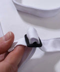 Close-up of adjustable neck strap on The Office Inspired Kevin's Famous Chili Cook-Off Fan Favorite Apron in 100% white cotton.