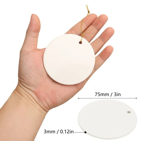 Close-up of hand holding a 40 Pieces Sublimation Ceramic Ornaments Blanks With Holes 2.95 Inch Round White Porcelain Disc