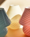 Swirl Mushroom Glass Lamp In Striped Pink, Hand Blown Translucent Murano Style Table Bedside Light with pastel lamps in background