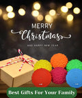 Hedgehog Balance Pods Set Of 6 In Multiple Colors beside a gift box for Christmas, with festive lights in the background.