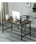 Slick Rolling Computer Desk Featuring Tight Vintage Industrial Lines And A Roomy Wood Surface Built For Home Office Setups With Heavy Duty Metal Base And Smooth Glide Casters, viewed from the side.