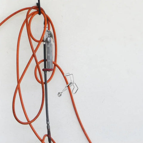Spring Flow Control Tube Clamps With Bracket Feet For Lab And Classroom Use attached to orange tubing setup