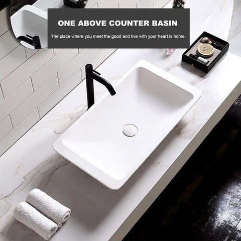 Slick Polished Artificial Stone Countertop Bathroom Sink With Integrated Drain Heavy Duty Oval Art Basin For Modern Vanity Cabinet Zero Hassle Scratch Proof Finish above counter view with black faucet and towels.