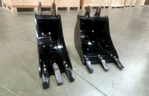 Two black buckets for BH6600HT Beefy Heavy Duty 3 Point Hitch Backhoe 7 ft digging depth with removable teeth on a warehouse floor.