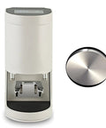 Automatic Espresso Tamping Station Featuring Smart Digital Sensors And A Mighty One Thousand Two Hundred Newton Force For Totally Flawless Extraction And Hella Consistent Shots Every Single Time, white design with stainless steel base and digital display.
