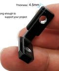 Close-up of 20Pcs L Shape Corner Bracket for 20 Series Aluminum Extrusion, black zinc alloy, held in hand, showing 4.5mm thickness.