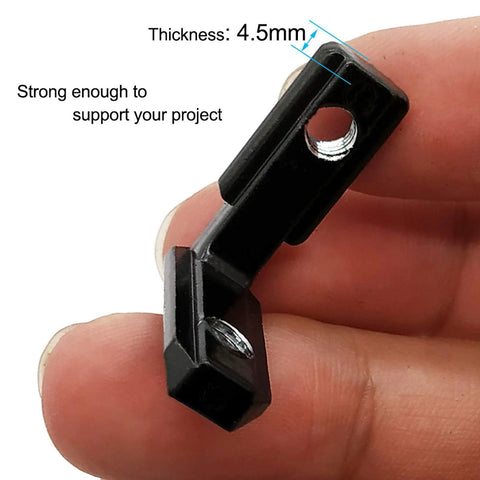 Close-up of 20Pcs L Shape Corner Bracket for 20 Series Aluminum Extrusion, black zinc alloy, held in hand, showing 4.5mm thickness.