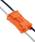 Close-up of Orange Two Wire Lighting Disconnect Plug 150 Pack With Push In Wire Locking Tech For Fast Safe Ballast Wiring On Your Fixtures And Easy Field Service Today connecting black and white wires.