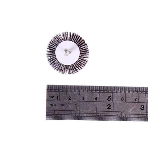 Single flap sanding wheel beside ruler, part of the 20 Pack 80 Grit Flap Wheel Sander Set With Pro Grade One Eighth Inch Shank, 32mm Diameter.