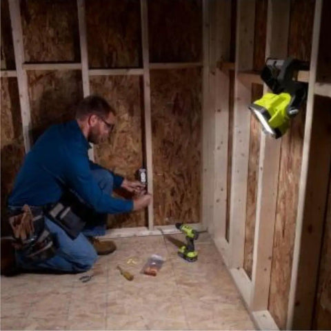 Person installing outlet using 18V Dual Power LED Work Light With 20 Watt LED And Over 1800 Lumens 360 Degree Rotating Head