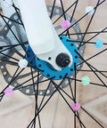 Multicolor Bicycle Spoke Beads Set With Luminous Plastic Clips on kids bike wheel, 72 piece decoration kit, close-up view