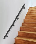 Heavy Duty Wall Mounted Stair Handrail Two Pack Black Stainless Steel Safety Grips Indoor Outdoor Hallway Railing on wooden stairs.
