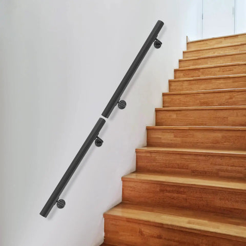 Rock Solid Wall Mounted Stair Handrail Crafted From Premium Black Stainless Steel Features A Sleek Modern Cylindrical Profile on wooden stairs.