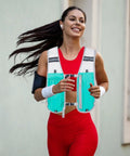 Woman running in Go To Hydration Vest For Running And Trail Gear With Multiple Pockets Lightweight Hydration Backpack