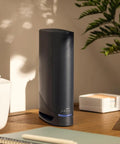 Black G34 Cable Modem Router Combo With DOCSIS 3.1 And WiFi 6 AX3000 on a desk next to office items