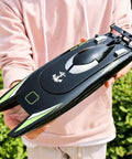 Person holding Crazy Fast RC Racing Boat For Adults With Dual Motors Two Point Four GHz Remote Control Waterproof Hull 32cm