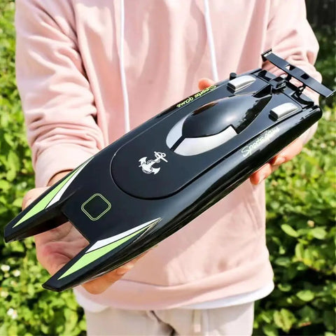 Person holding Crazy Fast RC Racing Boat For Adults With Dual Motors Two Point Four GHz Remote Control Waterproof Hull 32cm