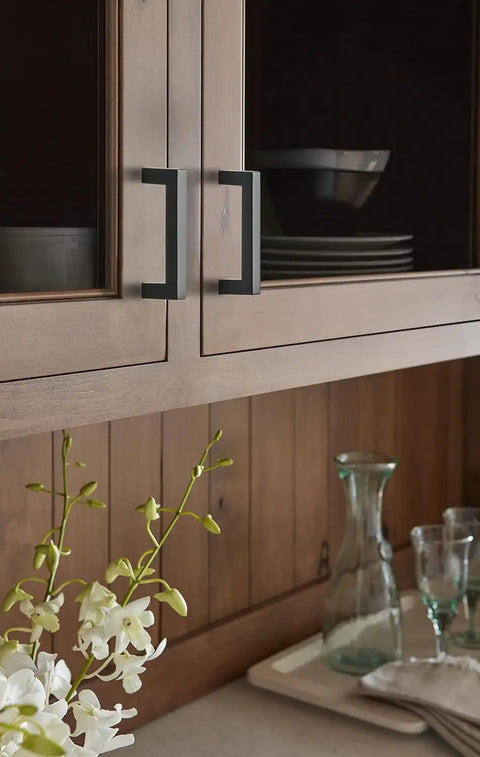 Sleek Contemporary Cabinet Pull In Matte Black Finish For Modern Kitchen Drawers And Furniture Hardware on wooden cabinetry.