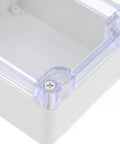 Sturdy White Plastic Junction Box With Clear Dustproof Cover For Electrical Project Setups showing corner detail and screw.