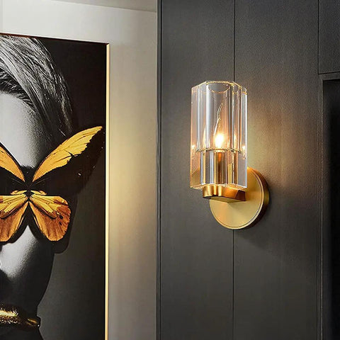 Super Sleek Modern Copper Brass Wall Sconce With Geometric Cylindrical Glass Shade For Bedroom Bedside And Living Room E14 Compatible Accent Lamp, mounted on dark wall beside art.