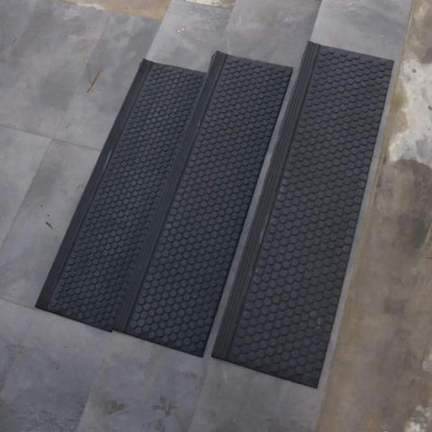 Coin-Grip Grit Surface Rubber Stair Tread Mats 10 Inch By 36 Inch, 6 Pack on gray surface, showing non-slip texture.