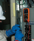 Electrician using Rugged Digital Multimeter With Auto-Ranging TRMS LoZ Ghost Voltage Elimination on electrical panel