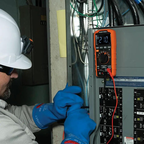 Electrician using Rugged Digital Multimeter With Auto-Ranging TRMS LoZ Ghost Voltage Elimination on electrical panel