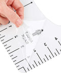 Close-up of a hand peeling film from a T-shirt ruler in the Heat Press Pillow Bundle Tools Kit With 4 Transfer Pillows In 4 Sizes