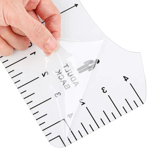 Close-up of a hand peeling film from a T-shirt ruler in the Heat Press Pillow Bundle Tools Kit With 4 Transfer Pillows In 4 Sizes