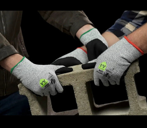 Two pairs of Griffin Gear ANSI A4 Liquid Repellent Nitrile Work Gloves lifting a concrete block, showing grip and protection.