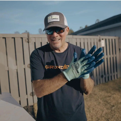 Person wearing Filet Gripper Glove With Non Slip Grip, Cut Resistant, Quick Dry, Breathable Second Skin Fit Fishing Glove In Neon outdoors.
