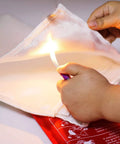 Hands holding a Must Have Fire Blanket Kit For Home And Kitchen Two Pack Grab And Go 3.3 By 3.3 Feet Fiberglass Flame Retardant Safety Gear.
