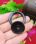 Close-up of a black Four Pack Vintage Ring Drawer Pulls For Dresser Cupboard Doors in zinc alloy, held in hand.