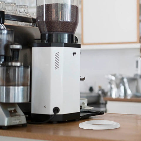 Premium Silicone Grouphead Gasket Replacement For Breville Casabrews Espresso Machines And More, shown next to a coffee grinder.