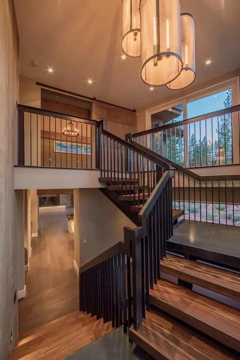 Real Deal Reclaimed Rustic Wood Stain Providing A Hella Smooth Water Based Finish That Reacts Naturally With Tannins To Create An Authentic Weathered Look Perfect For Interior Or Exterior Makeovers In A Convenient 55 Gallon Barrel showcased in modern staircase setting with elegant lighting.